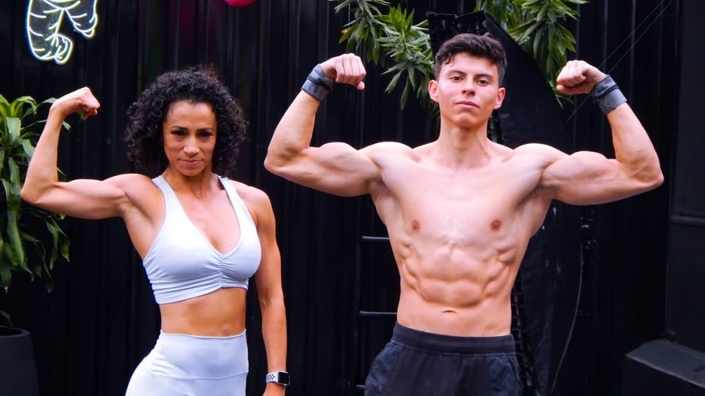 A fit man and woman flex muscles in activewear outdoors in Mexico City.